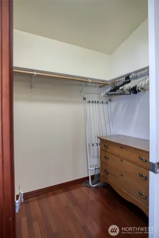 a view of walk in closet with empty racks