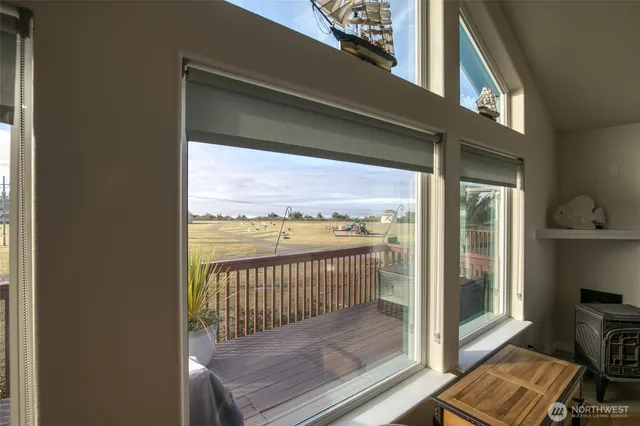 a view of a balcony with a floor to ceiling window and wooden floor