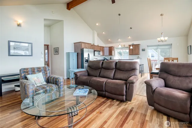a living room with furniture kitchen and a table