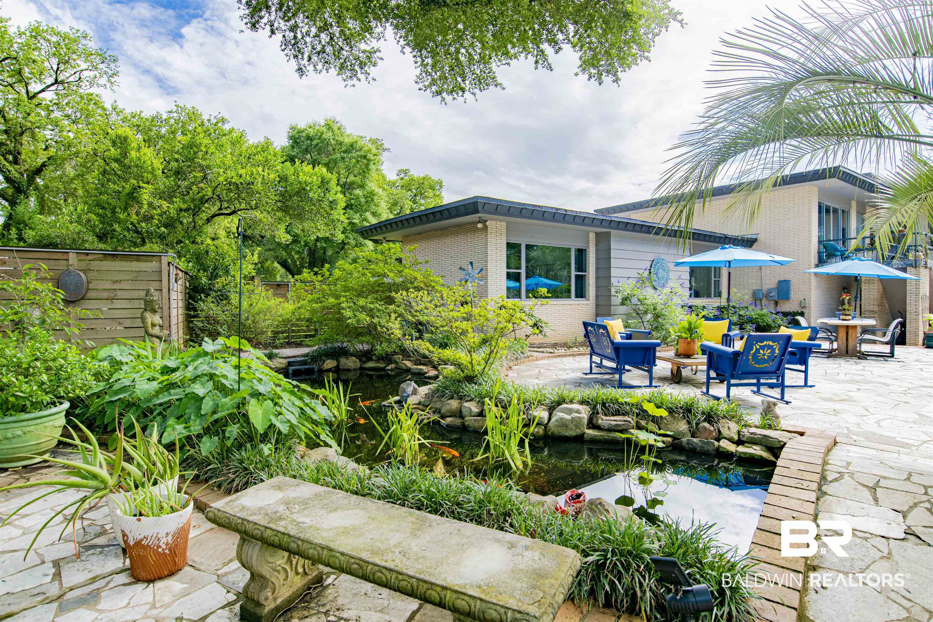 809 Bernard Circle Mobile, AL 36693 - Photo 57 of 75 Expansive flagstone patio area featuring a built-in koi pond with surrounding greenery