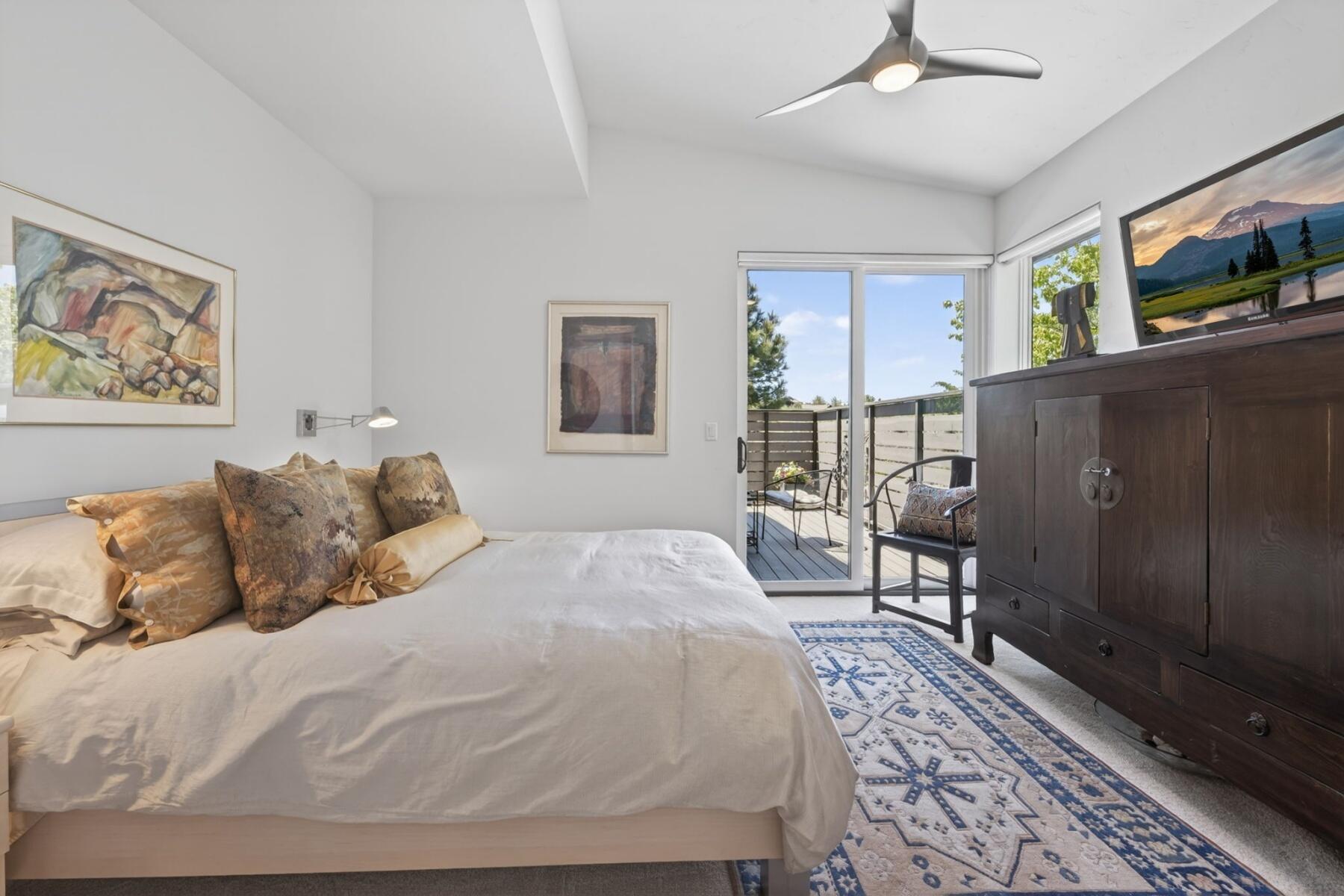 61487 Hackleman Court Bend, OR 97702 - Photo 27 of 35 a bed sitting in a bedroom and a chandelier in it
