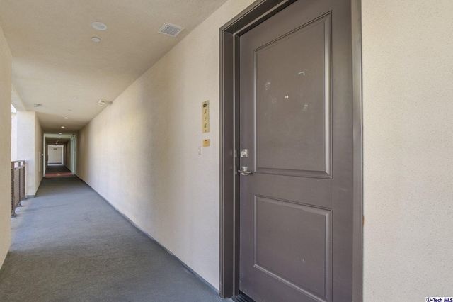 a large living room with stainless steel appliances granite countertop a couch and a view of kitchen