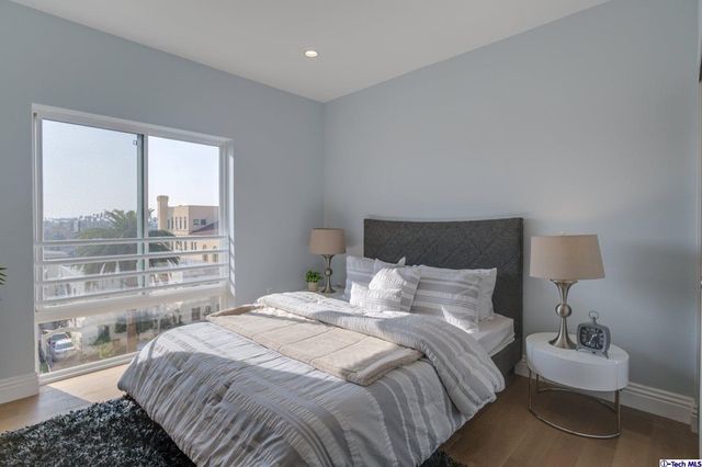 a bedroom with a bed and a night stand