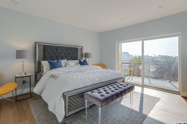 a bedroom with a bed and a wall painting