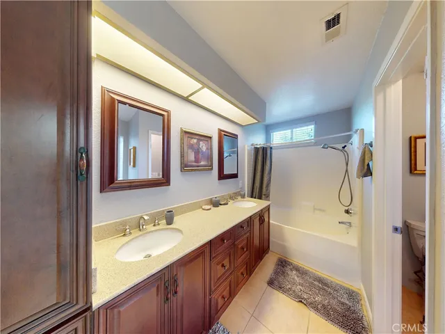 a spacious bathroom with a granite countertop sink mirror and a bathtub