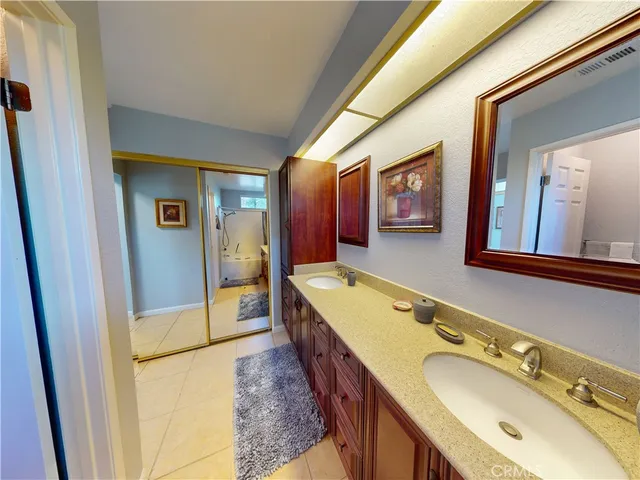a bathroom with a tub sink and mirror