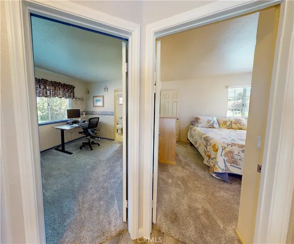 a bedroom with furniture and a large window