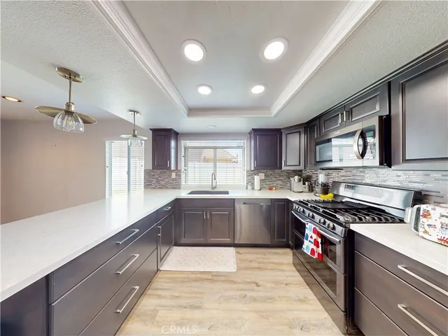 a kitchen with stainless steel appliances granite countertop a sink and stove top oven