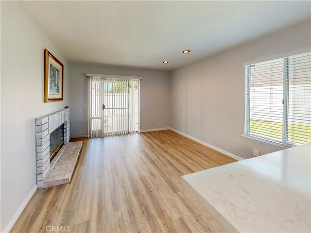 a view of a room with wooden floor and window