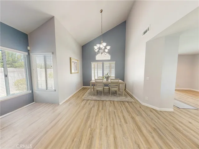 an empty room with wooden floor windows and outdoor view