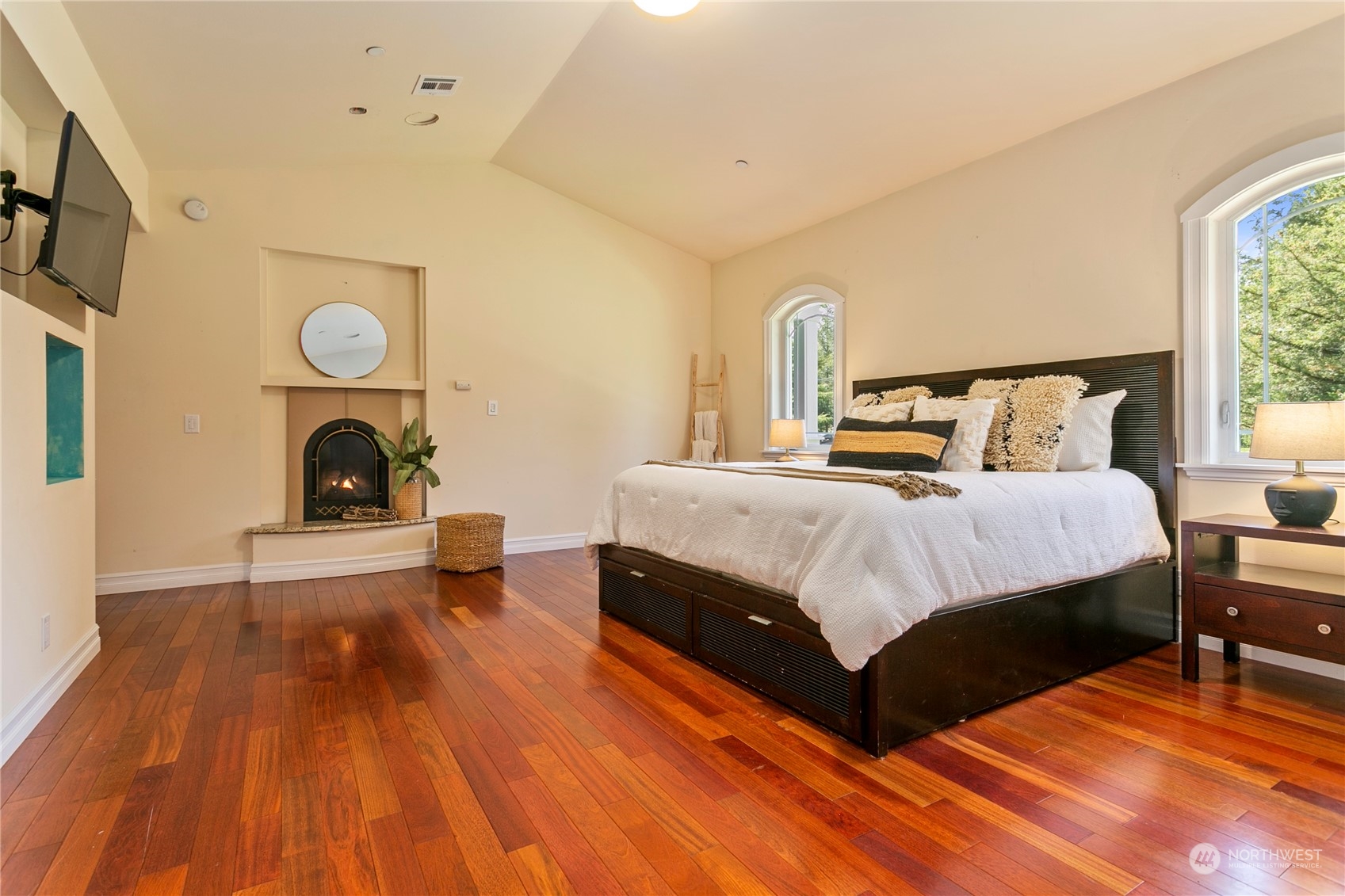 6082 Old Guide Road Bellingham, WA 98226 - Photo 23 of 39 a bedroom with a bed and a clock on dresser with wooden floor