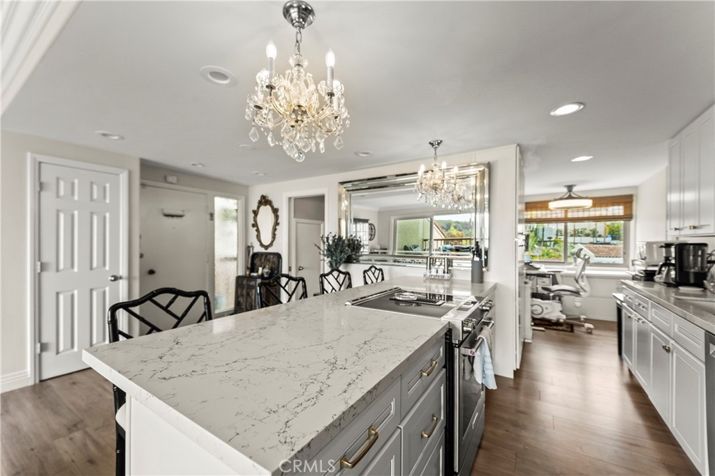 23920 De Ville Way, Unit D Malibu, CA 90265 - Photo 13 of 42 a view of a dining room with furniture a chandelier and wooden floor
