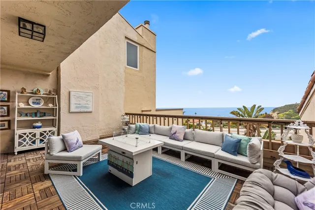 a balcony with furniture and wooden floor