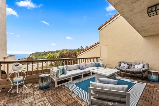a terrace with outdoor seating and city view