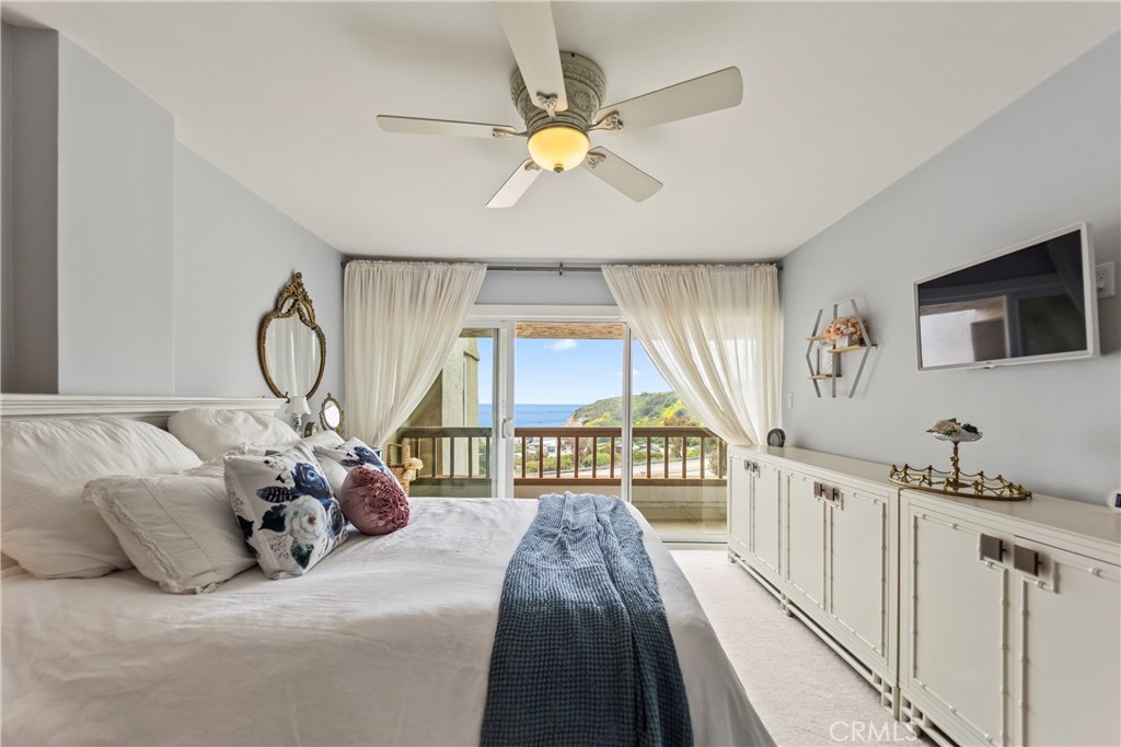 23920 De Ville Way, Unit D Malibu, CA 90265 - Photo 23 of 42 a bed room with a bed and a chandelier
