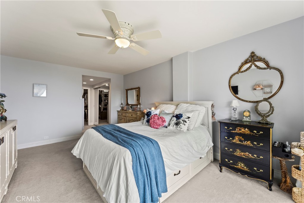 23920 De Ville Way, Unit D Malibu, CA 90265 - Photo 24 of 42 a bedroom with a bed a chandelier and a dresser