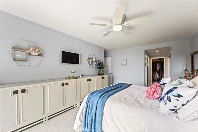 a bedroom with a large bed and a chandelier