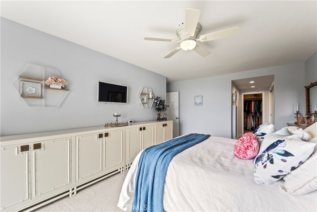 23920 De Ville Way, Unit D Malibu, CA 90265 - Photo 25 of 42 a bedroom with a large bed and a chandelier