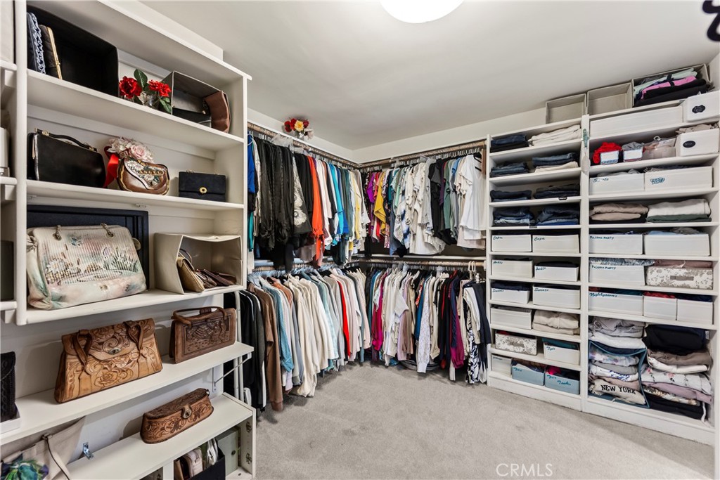 23920 De Ville Way, Unit D Malibu, CA 90265 - Photo 27 of 42 a view of walk in closet with clothes and shoes