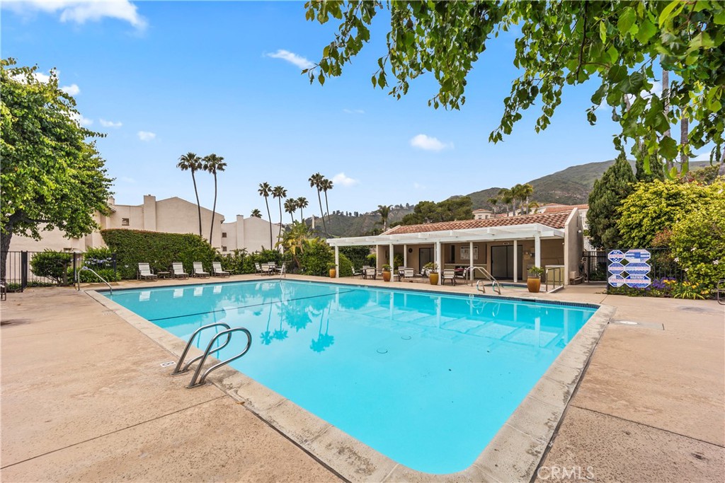 23920 De Ville Way, Unit D Malibu, CA 90265 - Photo 38 of 42 a view of a house with pool and a yard