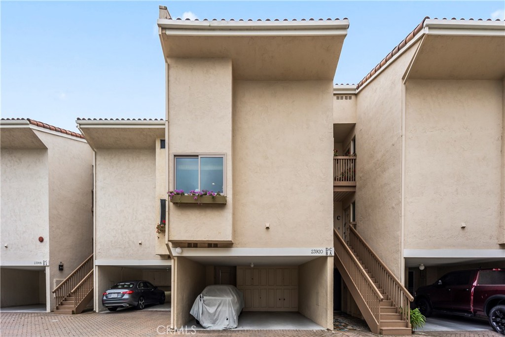 23920 De Ville Way, Unit D Malibu, CA 90265 - Photo 40 of 42 a car parked in front of a house
