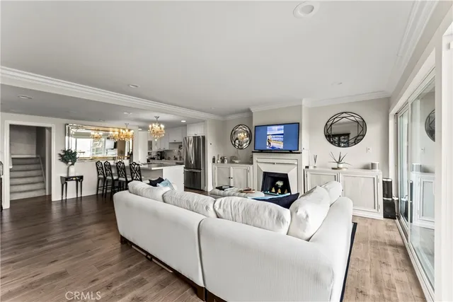 a living room with fireplace furniture and a large window