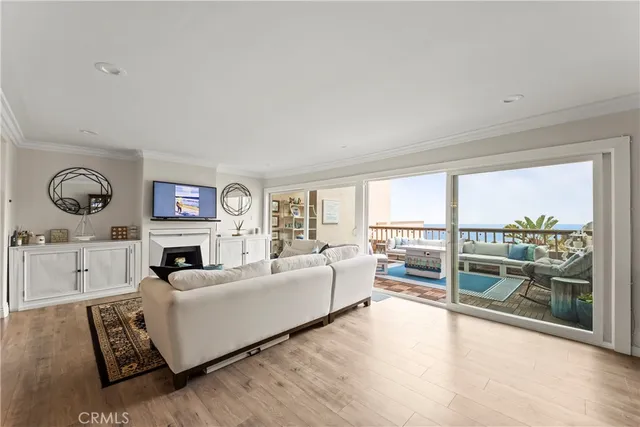 a living room with furniture a large window and a fireplace