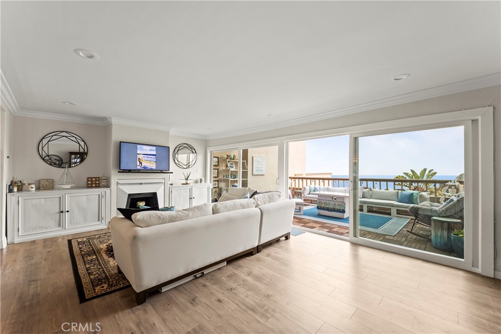 23920 De Ville Way, Unit D Malibu, CA 90265 - Photo 7 of 42 a living room with furniture a large window and a fireplace