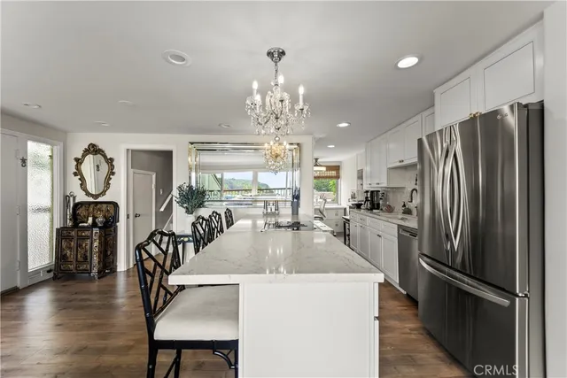 a kitchen with counter top space a refrigerator and windows