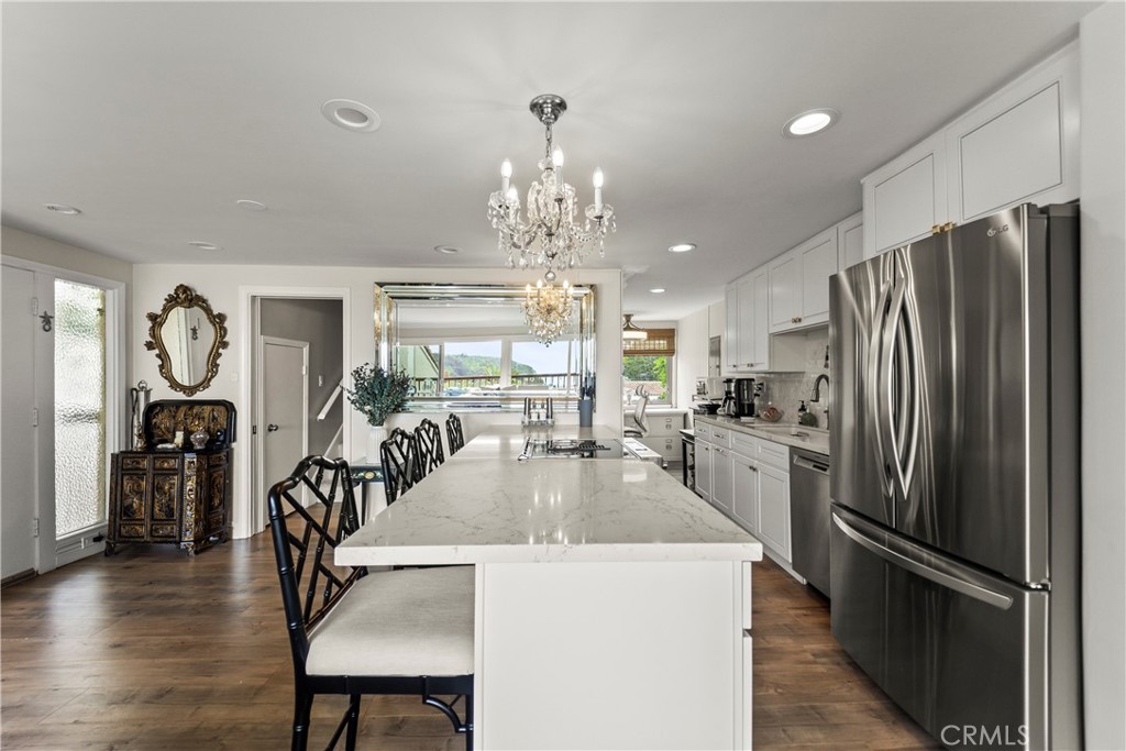 23920 De Ville Way, Unit D Malibu, CA 90265 - Photo 10 of 42 a kitchen with counter top space a refrigerator and windows