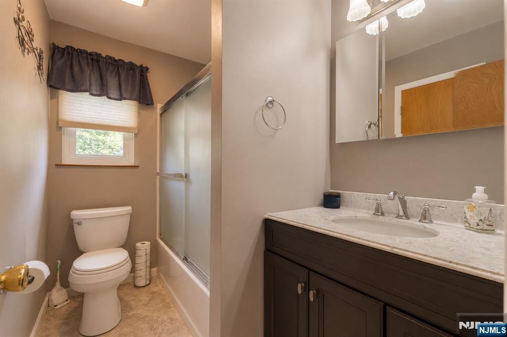 55 Marcia Road Ringwood, NJ 07456 - Photo 21 of 42 a bathroom with a toilet sink and mirror