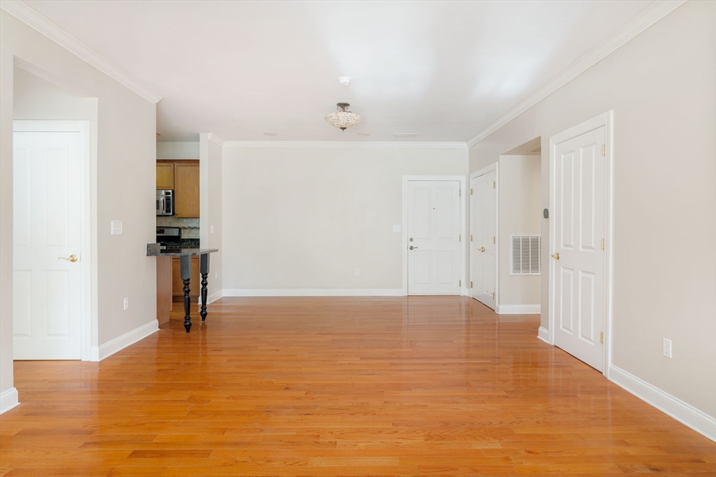 248 Albion Street, Unit 321 Wakefield, MA 01880 - Photo 4 of 19 a view of empty room with wooden floor