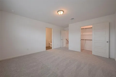 a view of an empty room with a closet