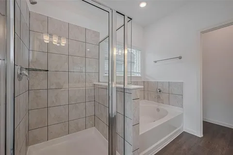 a bathroom with a bathtub and shower