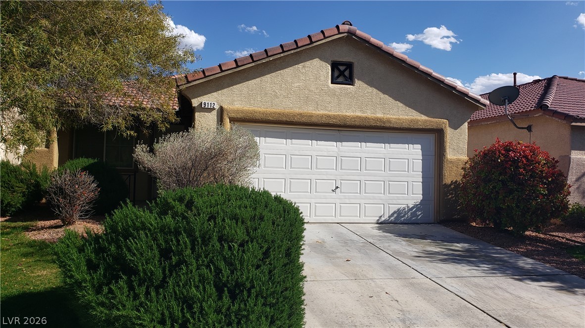 9112 Manalang Road Las Vegas, NV 89123 - Photo 3 of 50 A well-maintained stucco home with a tile roof and attached garage awaits.