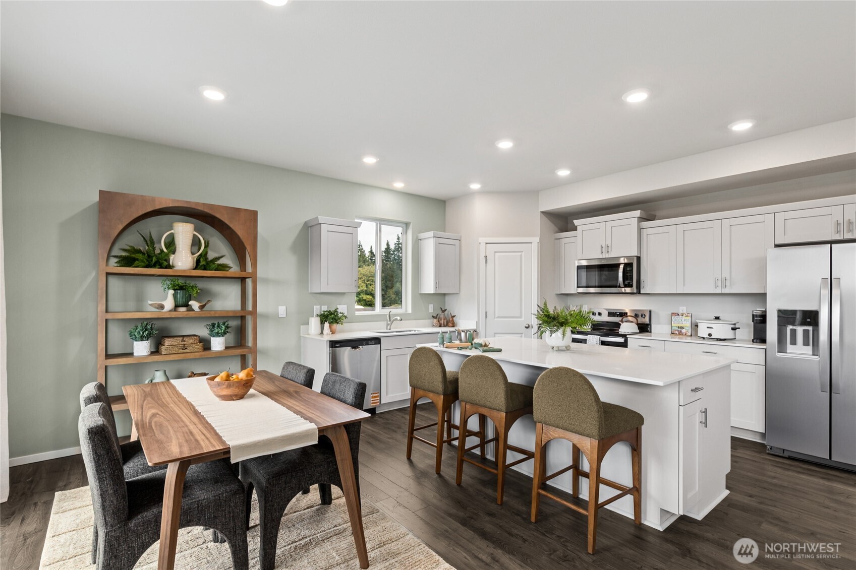536 Wall Street, Unit 33 Buckley, WA 98321 - Photo 3 of 40 a dining room with stainless steel appliances kitchen island granite countertop a dining table and chairs