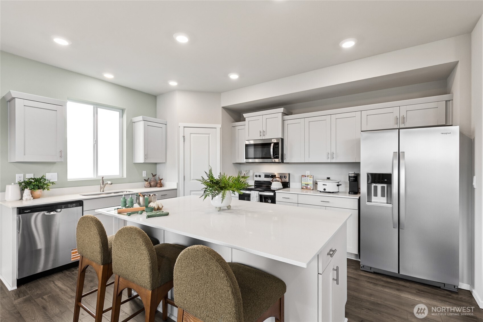 536 Wall Street, Unit 33 Buckley, WA 98321 - Photo 7 of 40 a kitchen with stainless steel appliances granite countertop a refrigerator a sink dishwasher a stove and white cabinets with wooden floor