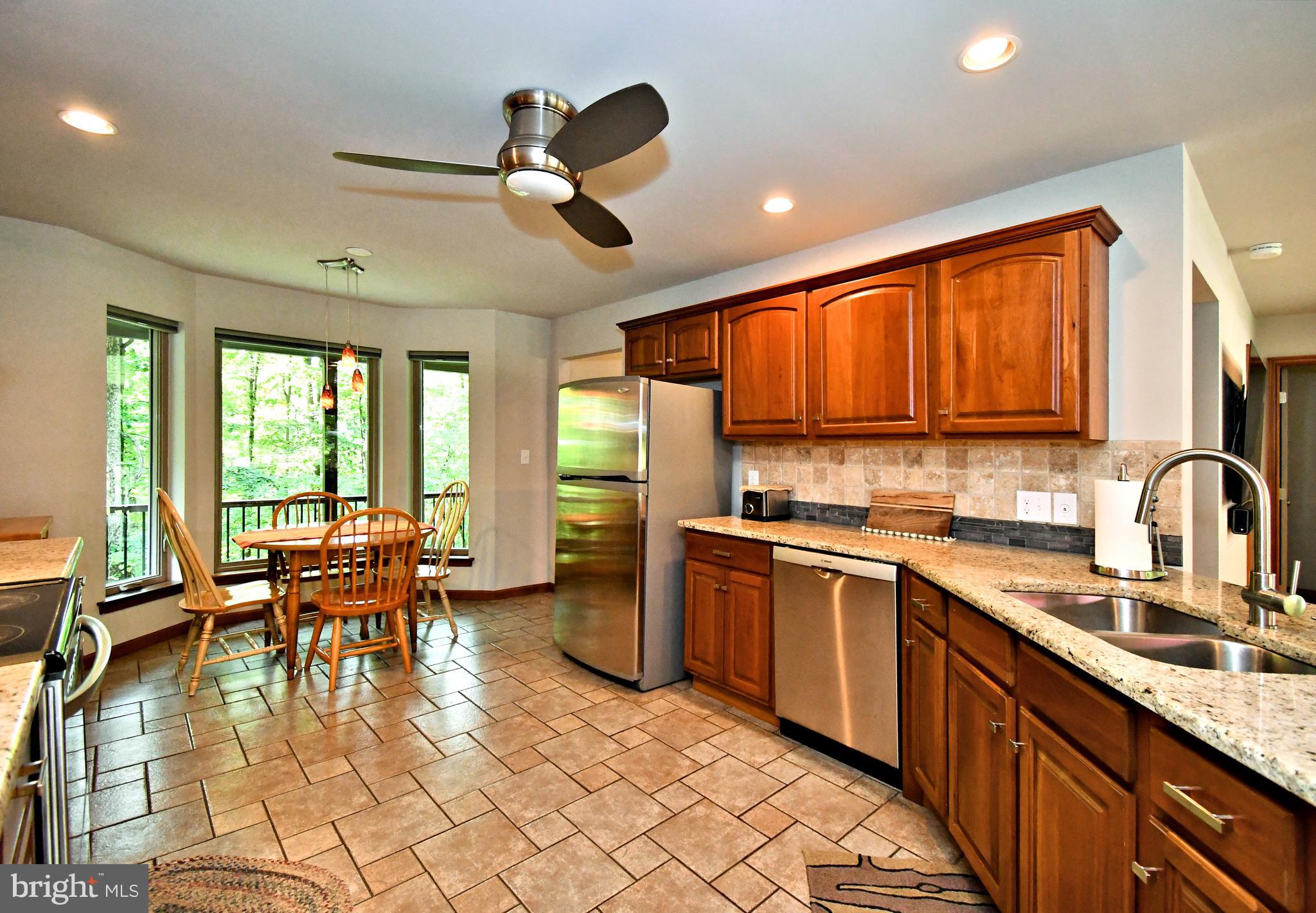 2415 Schaffer Road Pottstown, PA 19464 - Photo 18 of 93 a kitchen with stainless steel appliances granite countertop sink stove dining table and chairs