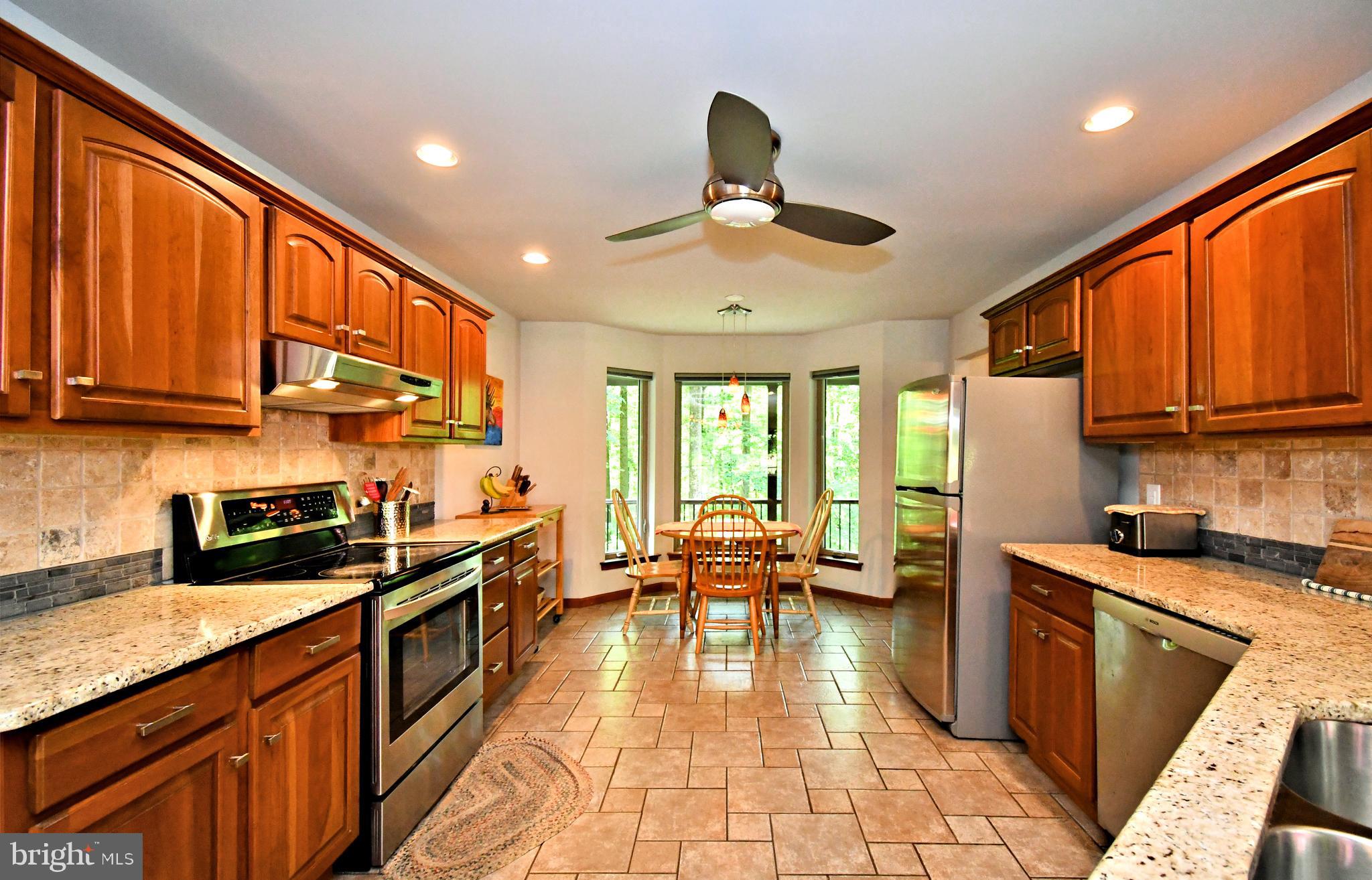 2415 Schaffer Road Pottstown, PA 19464 - Photo 19 of 93 a kitchen with stainless steel appliances granite countertop wooden cabinets a sink dishwasher a stove and a refrigerator with wooden floor