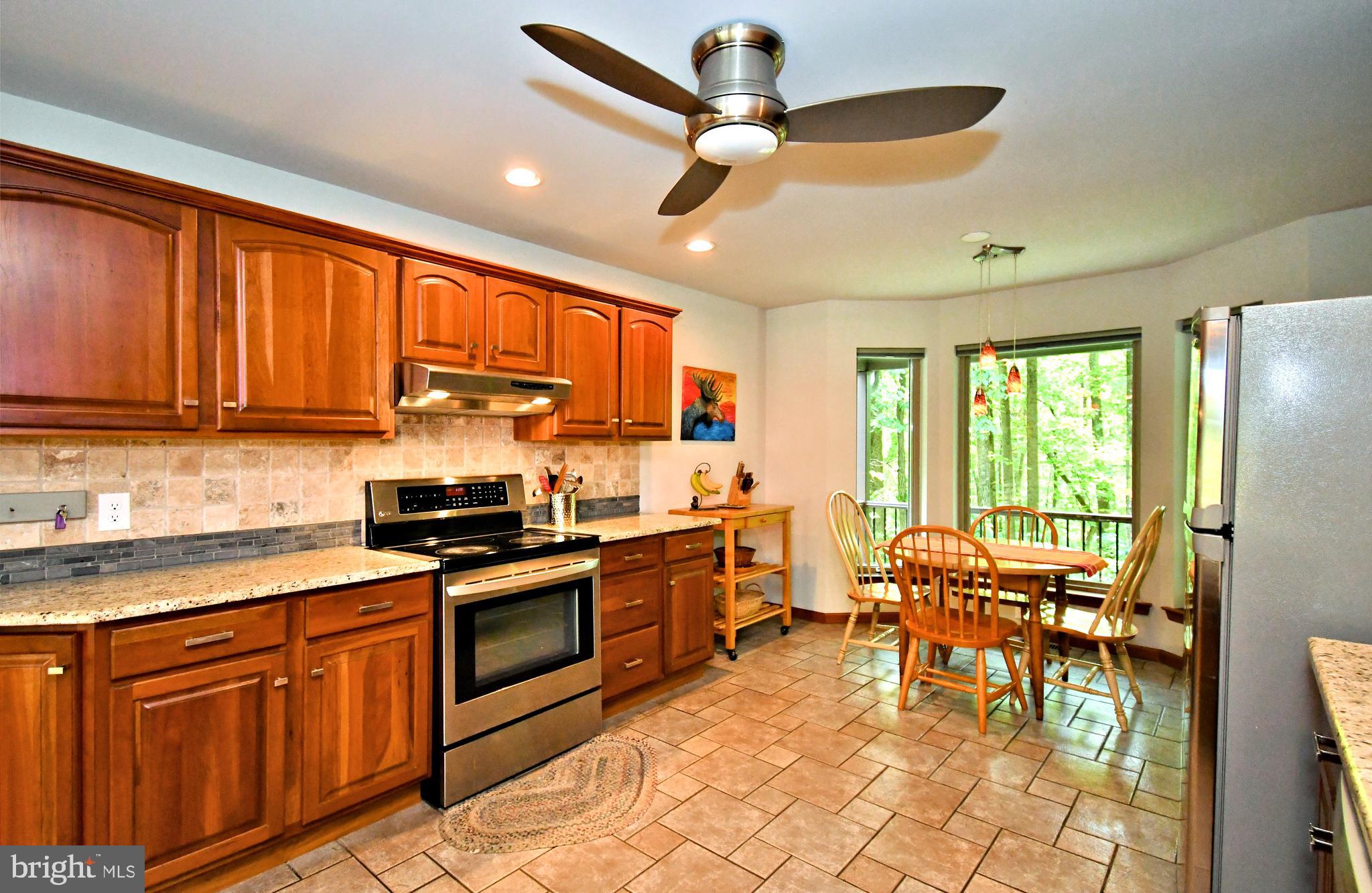 2415 Schaffer Road Pottstown, PA 19464 - Photo 20 of 93 a kitchen with stainless steel appliances granite countertop dining table chairs sink and cabinets