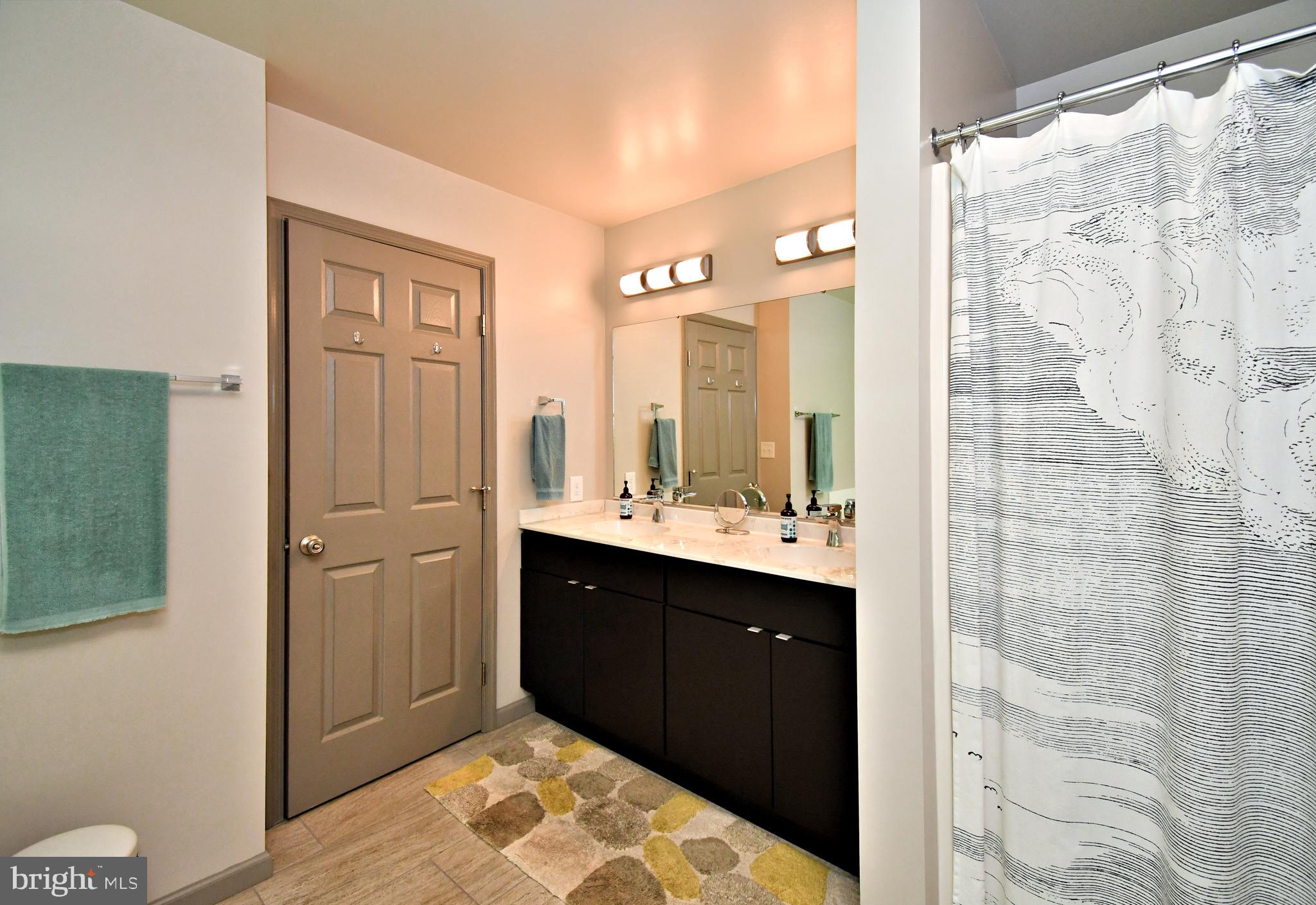 2415 Schaffer Road Pottstown, PA 19464 - Photo 38 of 93 a spacious bathroom with a double vanity sink a mirror and a shower