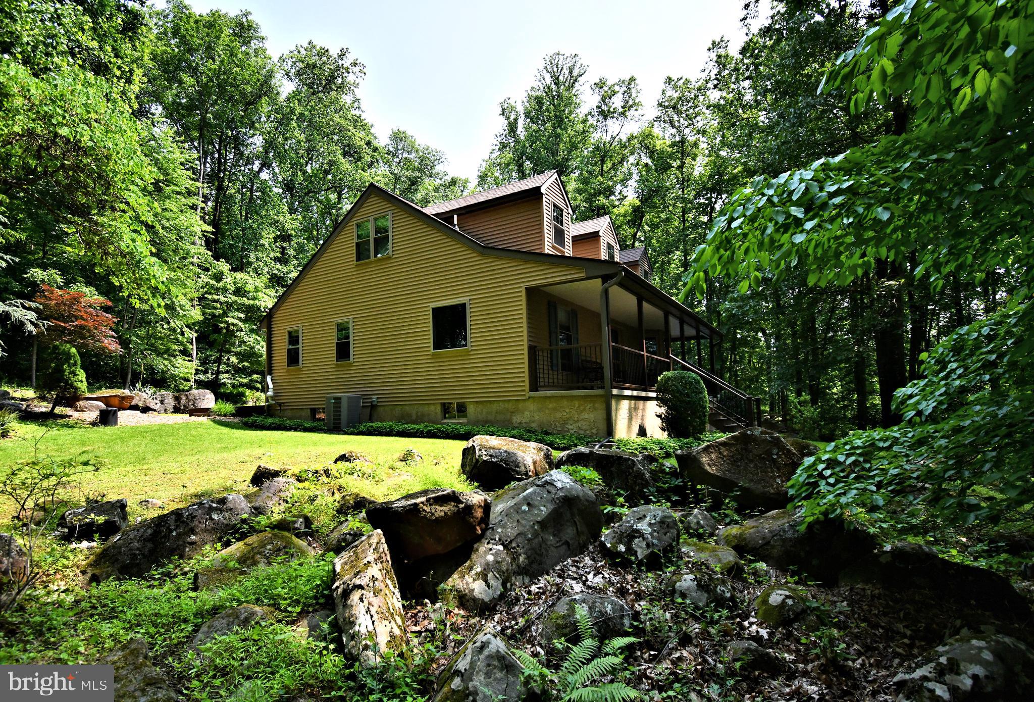 2415 Schaffer Road Pottstown, PA 19464 - Photo 4 of 93 a backyard of a house with outdoor seating and green space