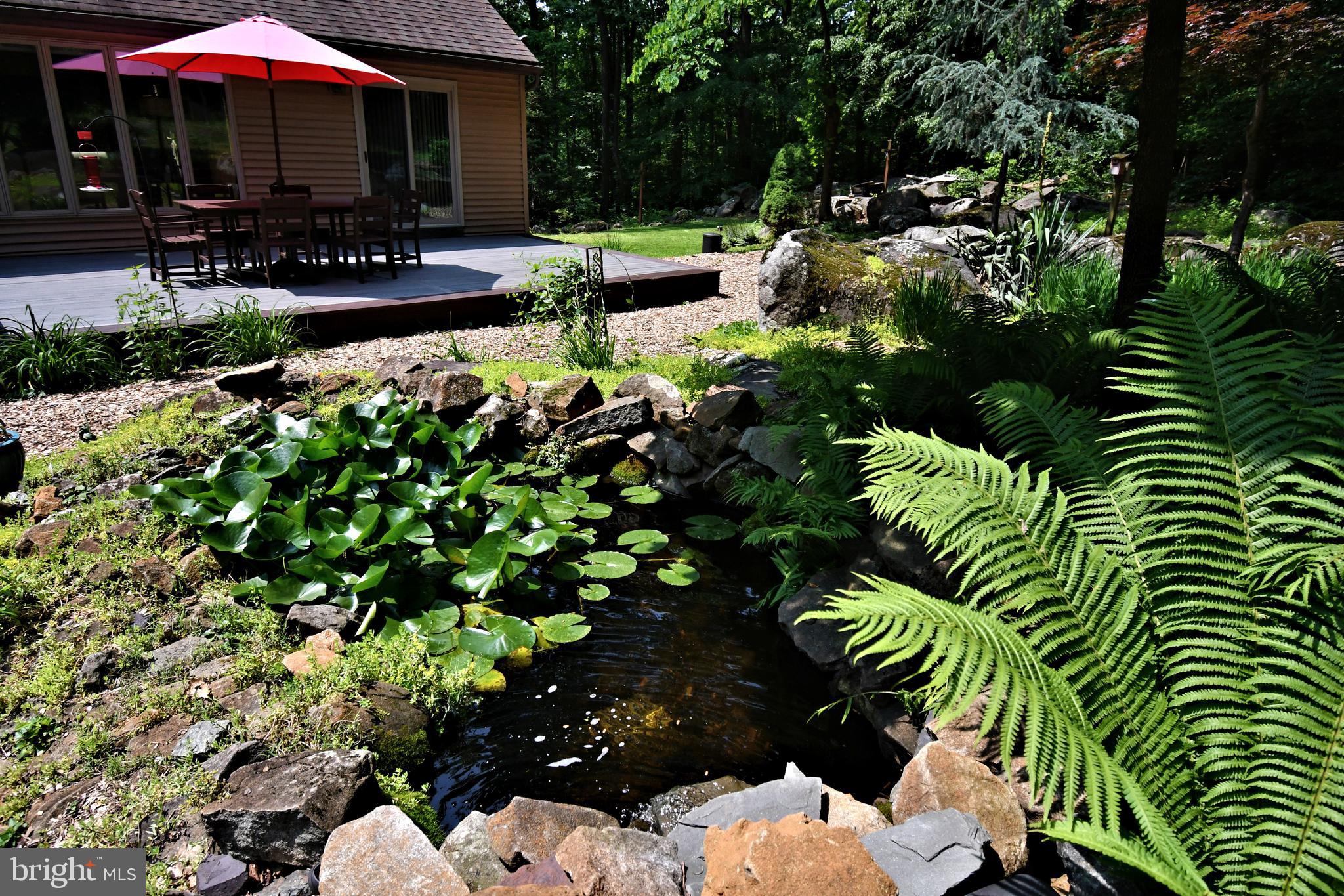 2415 Schaffer Road Pottstown, PA 19464 - Photo 82 of 93 a view of a patio with table and chairs under an umbrella