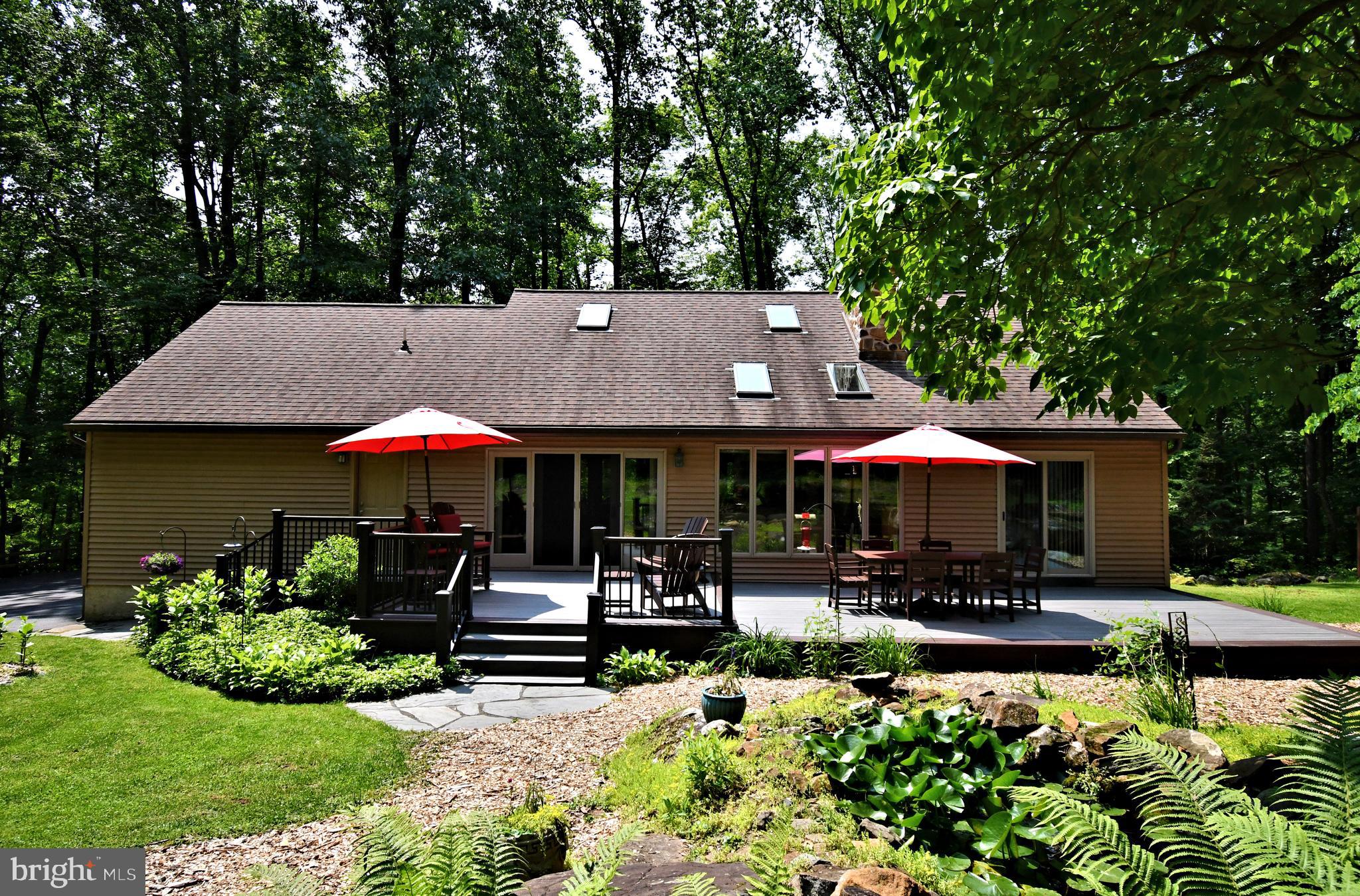 2415 Schaffer Road Pottstown, PA 19464 - Photo 89 of 93 a view of a patio with table and chairs under an umbrella