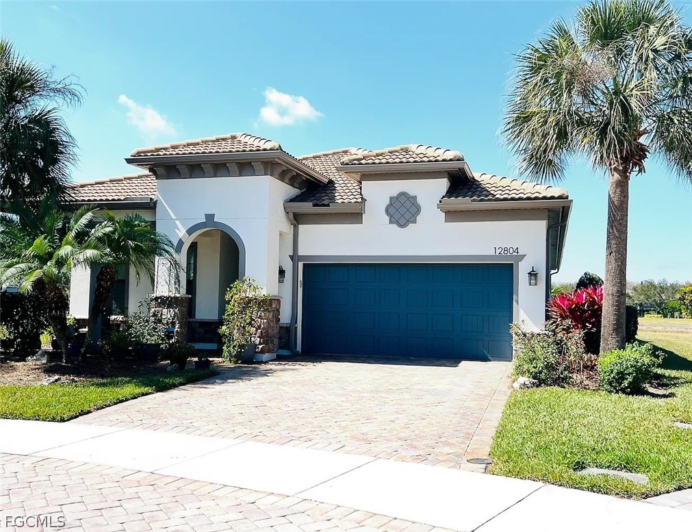 12804 Epping Way Fort Myers, FL 33913 - Photo 1 of 15 a front view of a house with a yard and garage