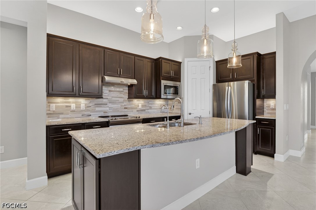 12804 Epping Way Fort Myers, FL 33913 - Photo 11 of 40 a kitchen with stainless steel appliances granite countertop a sink refrigerator and microwave