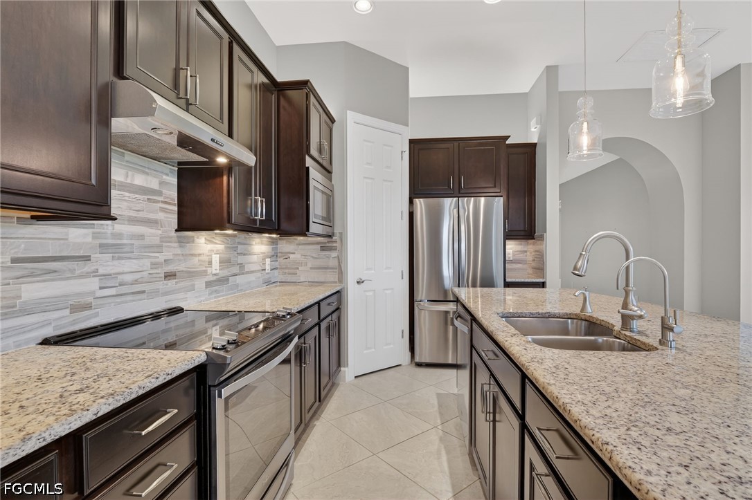12804 Epping Way Fort Myers, FL 33913 - Photo 12 of 40 a kitchen with stainless steel appliances granite countertop a sink stove and refrigerator