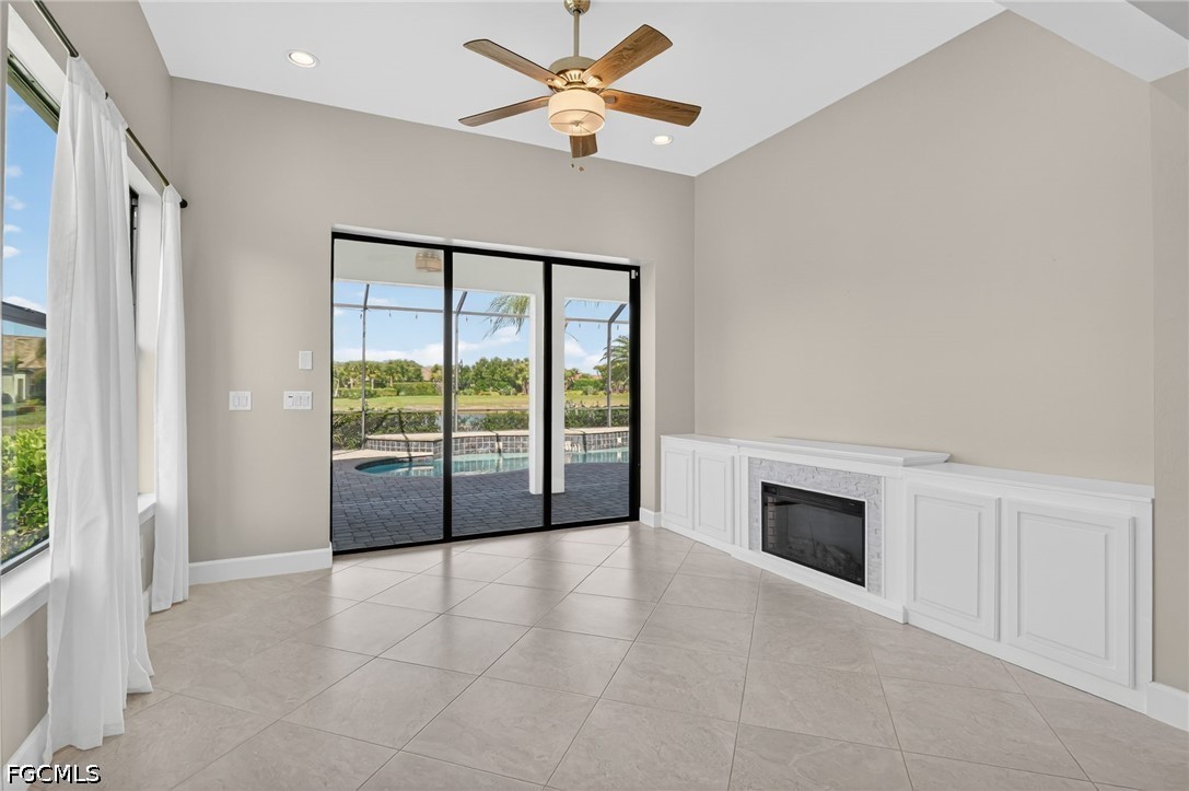 12804 Epping Way Fort Myers, FL 33913 - Photo 15 of 40 a view of an empty room with a fireplace and a window