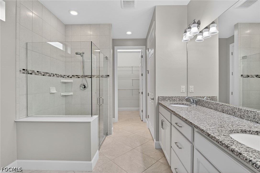 12804 Epping Way Fort Myers, FL 33913 - Photo 19 of 40 a spacious bathroom with a granite countertop sink mirror and shower
