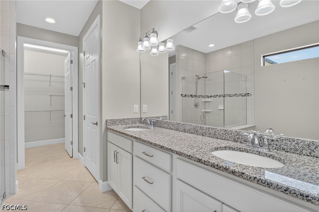 12804 Epping Way Fort Myers, FL 33913 - Photo 20 of 40 a bathroom with a granite countertop double vanity sink mirror and shower
